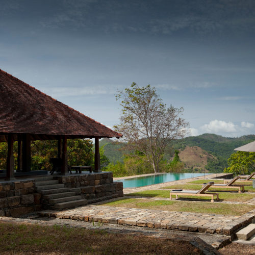 Outdoor pool and lounge area at Koslanda